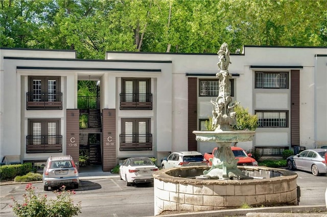 1445 Monroe Dr NE Unit C13, Atlanta, GA 30324 - view of front of home featuring french doors, stucco siding, and uncovered parking