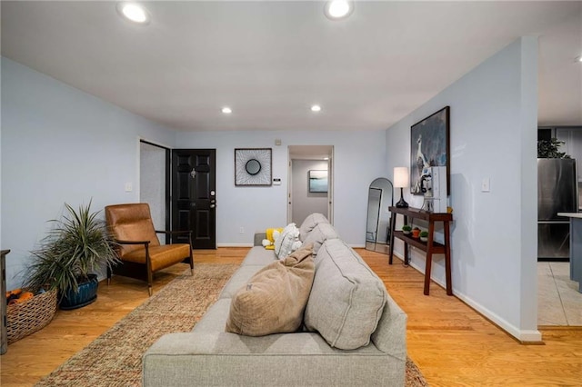 1445 Monroe Dr NE Unit C13, Atlanta, GA 30324 - living room with light wood-style flooring, recessed lighting, baseboards, and arched walkways