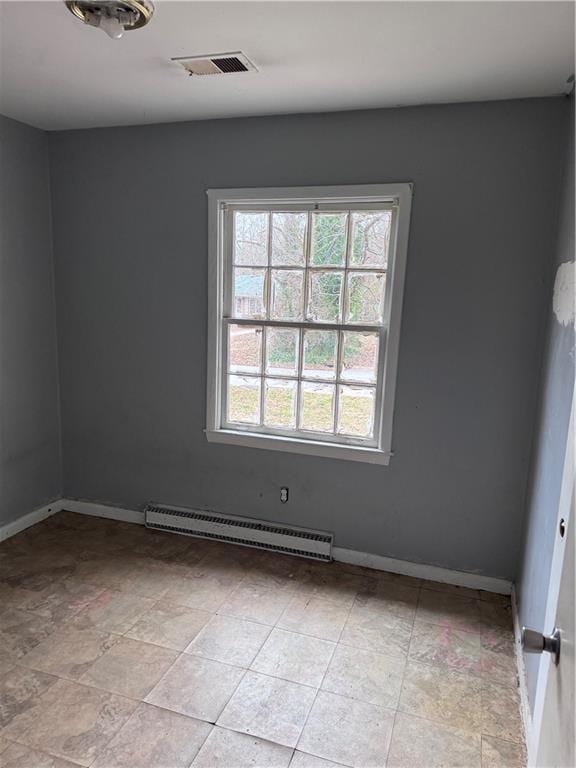 empty room featuring a baseboard heating unit