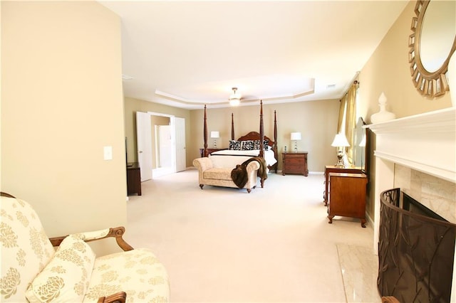 318 Ivy Manor Dr NW, Marietta, GA 30064 - bedroom featuring a tiled fireplace, a tray ceiling, carpet floors, and baseboards