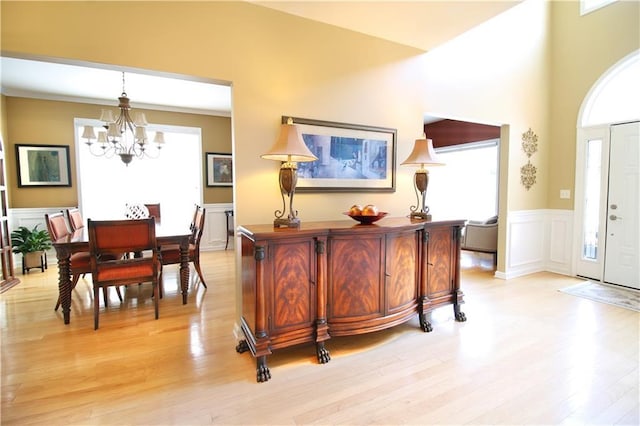 318 Ivy Manor Dr NW, Marietta, GA 30064 - foyer entrance featuring a chandelier, light wood finished floors, wainscoting, and a decorative wall