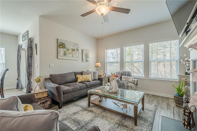 living room featuring wood finished floors, ceiling fan, and baseboards