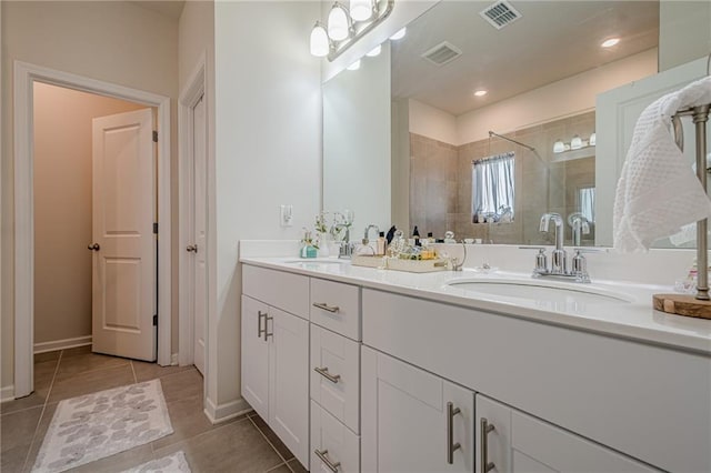 bathroom featuring walk in shower, tile patterned floors, double vanity, and baseboards