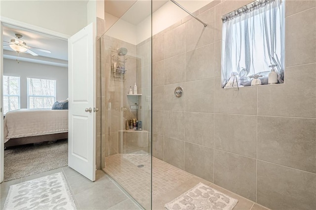 bathroom featuring connected bathroom, a ceiling fan, tile patterned flooring, and a walk in shower
