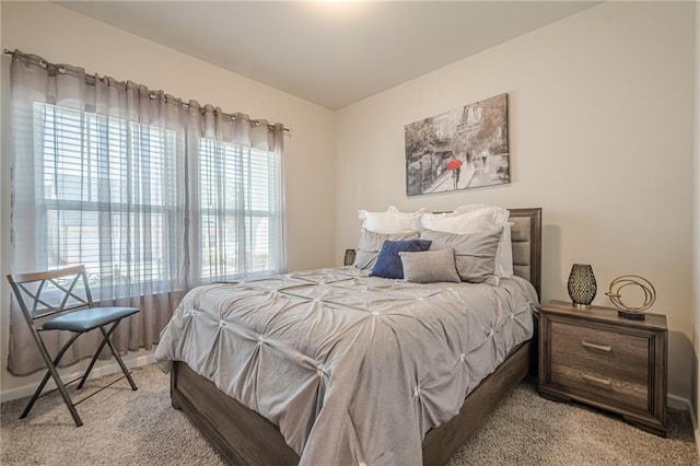 bedroom with carpet floors and baseboards