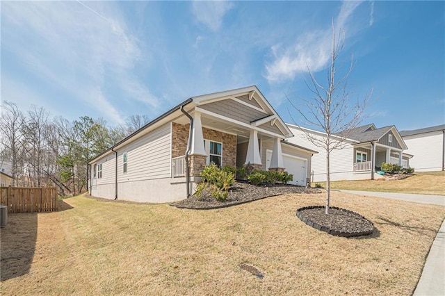 craftsman-style house featuring a porch, an attached garage, stone siding, concrete driveway, and central AC unit