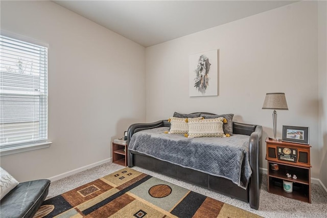 carpeted bedroom featuring baseboards
