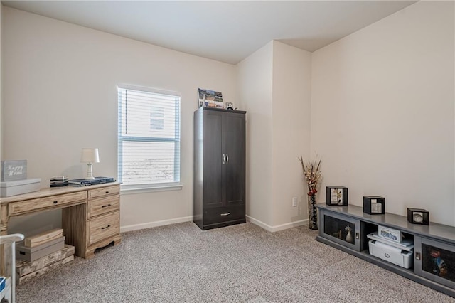 home office with light colored carpet and baseboards