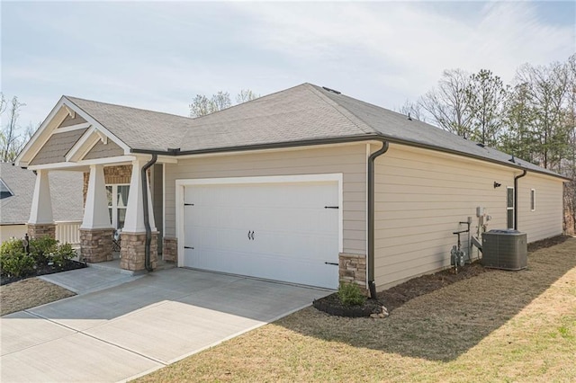view of property exterior with cooling unit, an attached garage, stone siding, and concrete driveway