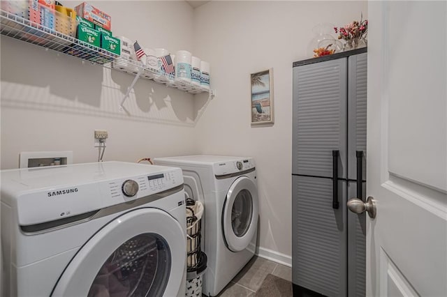 clothes washing area featuring washing machine and clothes dryer and baseboards