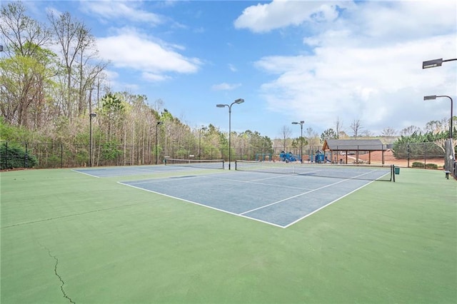 view of tennis court with fence and community basketball court