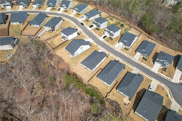 aerial view of property and surrounding area featuring nearby suburban area