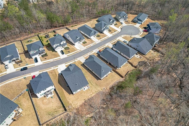 aerial view of property and surrounding area featuring nearby suburban area