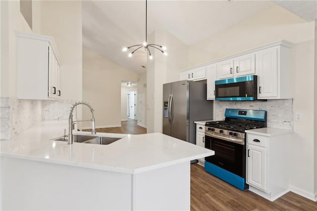 kitchen with white cabinetry, sink, kitchen peninsula, and appliances with stainless steel finishes