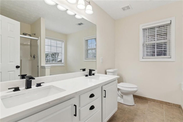 bathroom with walk in shower, tile patterned floors, vanity, and toilet