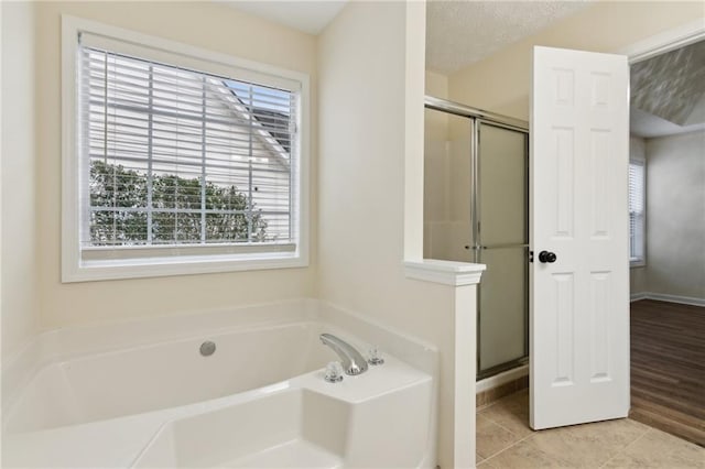 bathroom featuring independent shower and bath and tile patterned flooring