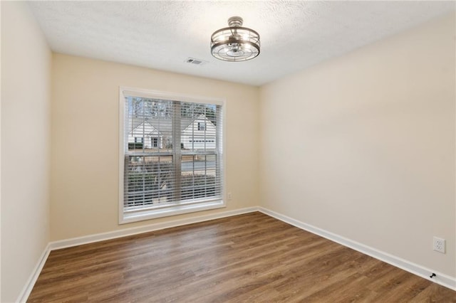 unfurnished dining area featuring hardwood / wood-style flooring and a textured ceiling