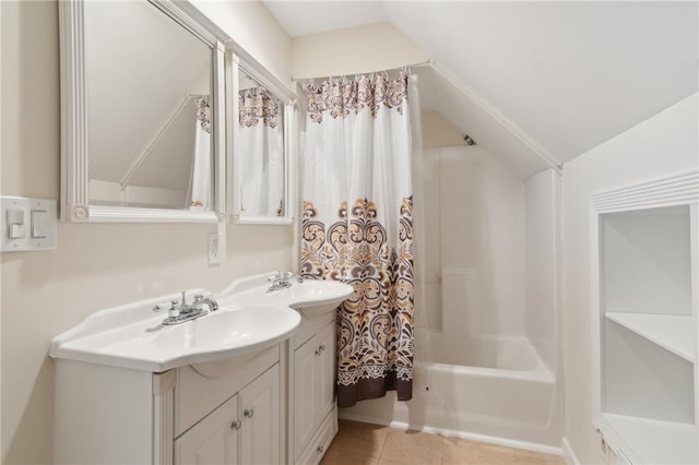 bathroom featuring vanity, vaulted ceiling, tile patterned floors, and bathing tub / shower combination