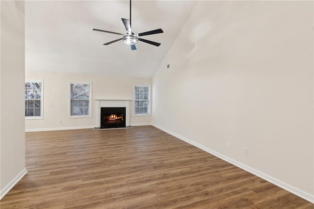 unfurnished living room with dark wood-type flooring, high vaulted ceiling, and ceiling fan