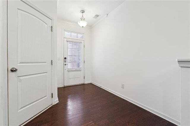 doorway featuring dark wood-style floors, visible vents, crown molding, and baseboards