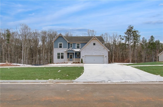 view of front of property featuring driveway, a garage, and a front lawn