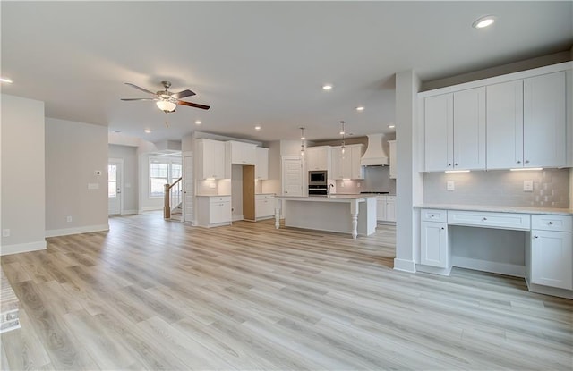 unfurnished living room featuring ceiling fan, baseboards, light wood-style flooring, and recessed lighting