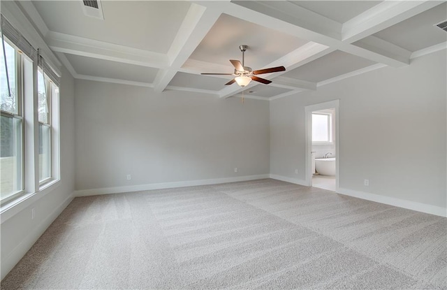 unfurnished room with coffered ceiling, beam ceiling, light carpet, and baseboards