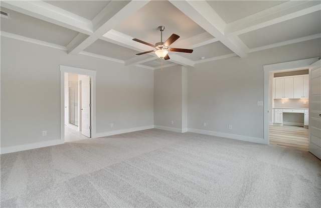 unfurnished bedroom featuring light carpet, baseboards, coffered ceiling, and beam ceiling