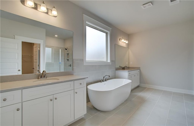 bathroom with two vanities, visible vents, a sink, and a shower stall