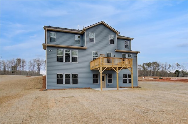 back of property featuring a deck and a patio area