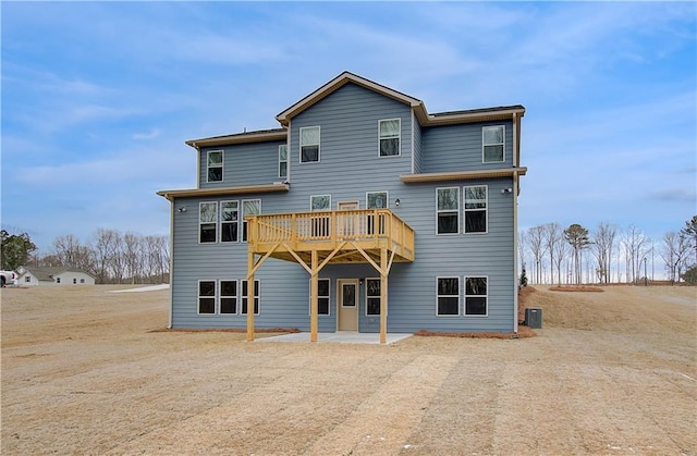 rear view of house featuring a patio area and central AC