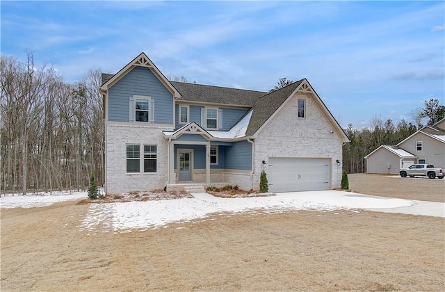 view of front of property featuring a garage and brick siding