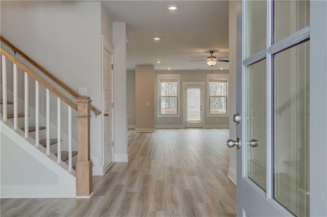 entryway featuring baseboards, ceiling fan, stairway, light wood-type flooring, and recessed lighting