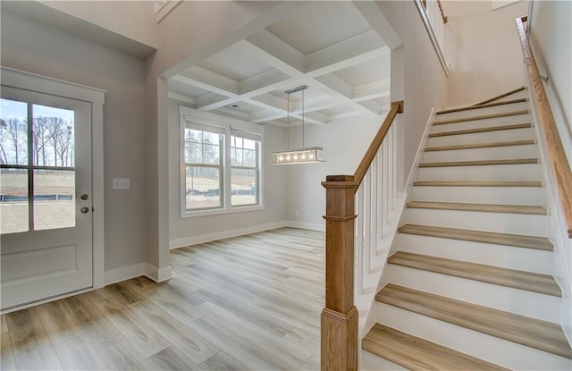 entryway with light wood-type flooring, plenty of natural light, baseboards, and coffered ceiling