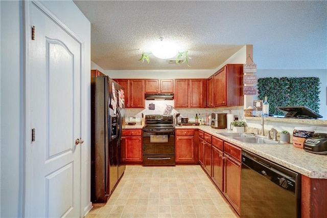 kitchen with under cabinet range hood, light countertops, a textured ceiling, black appliances, and a sink