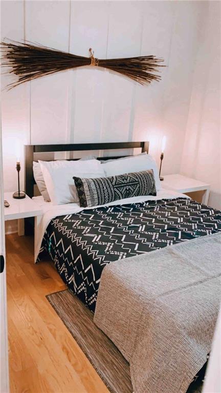 bedroom with wood-type flooring