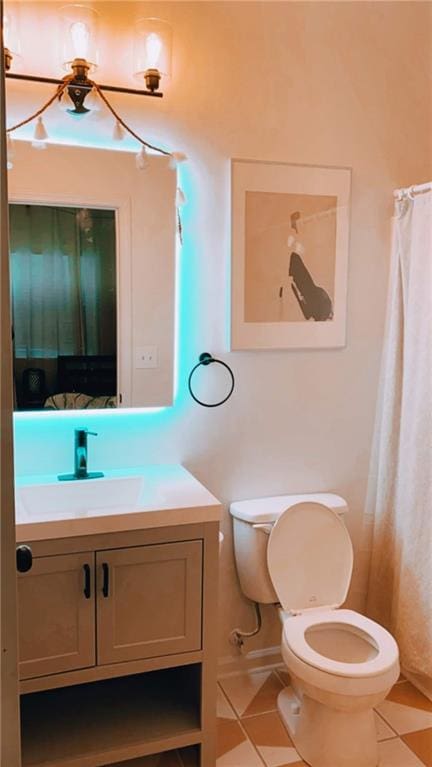 bathroom featuring tile patterned floors, vanity, toilet, and curtained shower