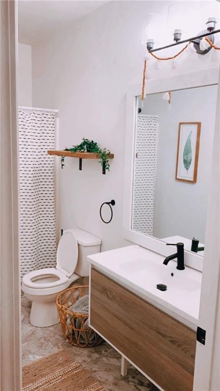 bathroom featuring vanity, toilet, and curtained shower