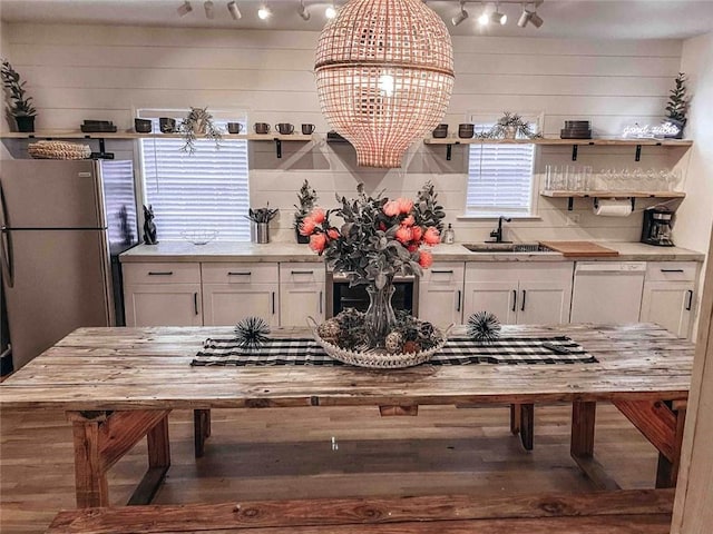 kitchen featuring butcher block counters, sink, white cabinetry, stainless steel refrigerator, and white dishwasher