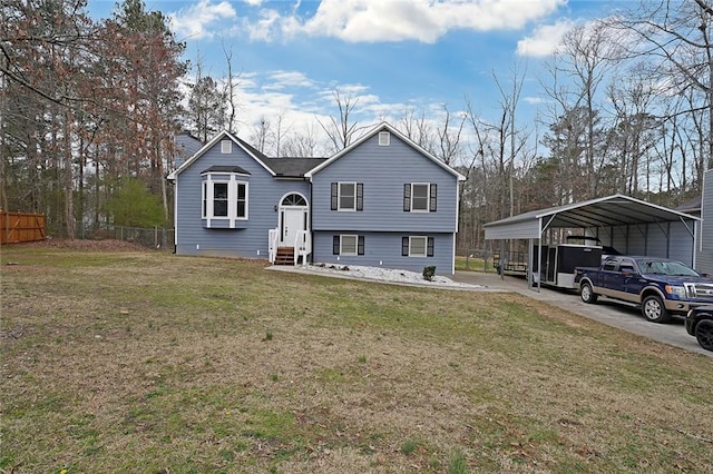 view of front of home with a detached carport, a front lawn, fence, and entry steps