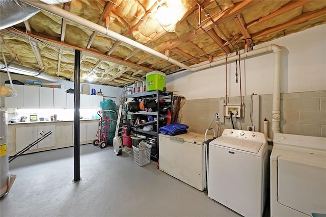 unfinished below grade area with washer and clothes dryer and refrigerator