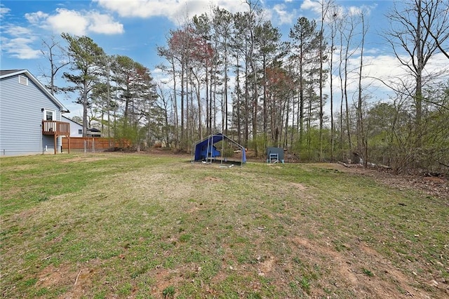 view of yard with a detached carport and fence