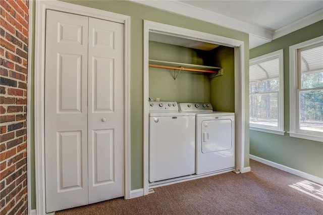 washroom featuring independent washer and dryer, carpet floors, ornamental molding, and brick wall