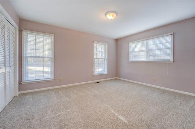 spare room featuring carpet and a healthy amount of sunlight