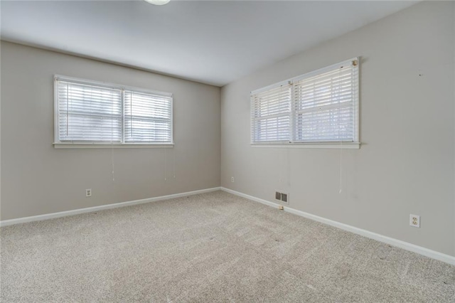 carpeted empty room featuring a wealth of natural light