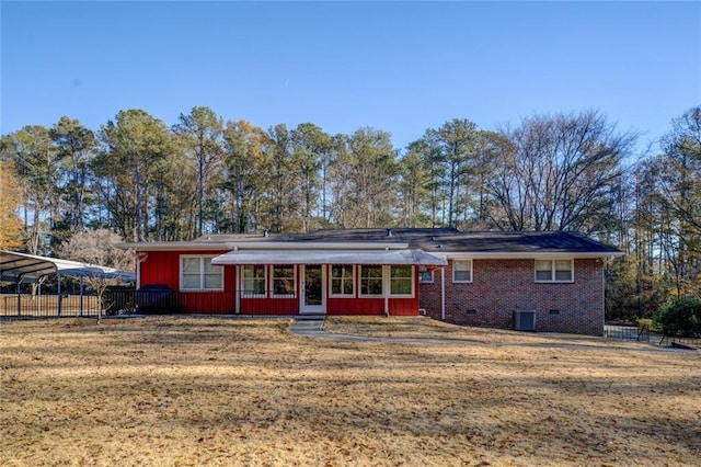 rear view of property with a carport and central air condition unit