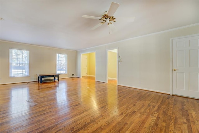 empty room featuring ceiling fan, ornamental molding, and hardwood / wood-style flooring