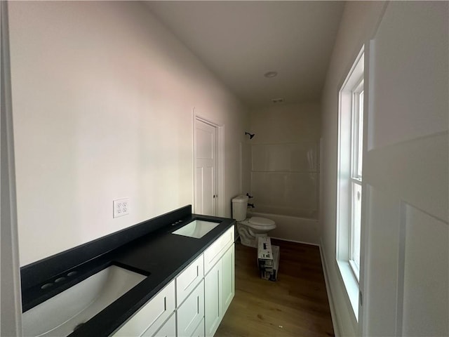 55 Noah Mountain Rd, Dahlonega, GA 30533 - full bath featuring wood finished floors, toilet, double vanity, and bathtub / shower combination