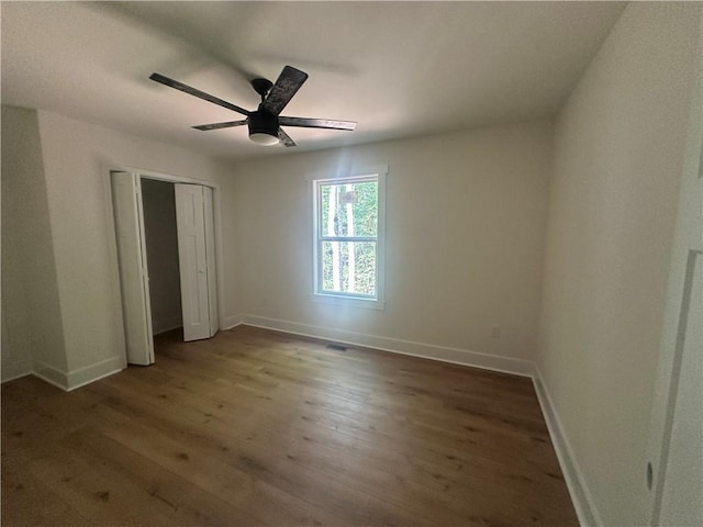 55 Noah Mountain Rd, Dahlonega, GA 30533 - unfurnished bedroom featuring wood finished floors, baseboards, a closet, and a ceiling fan
