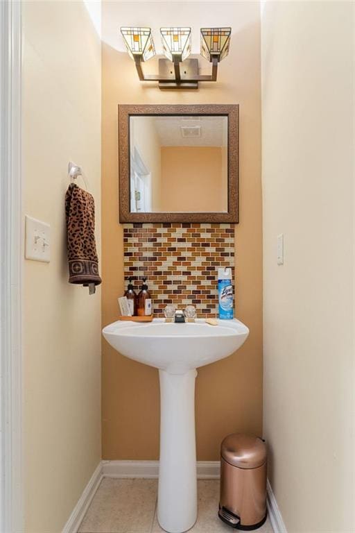 bathroom with tile patterned flooring and backsplash